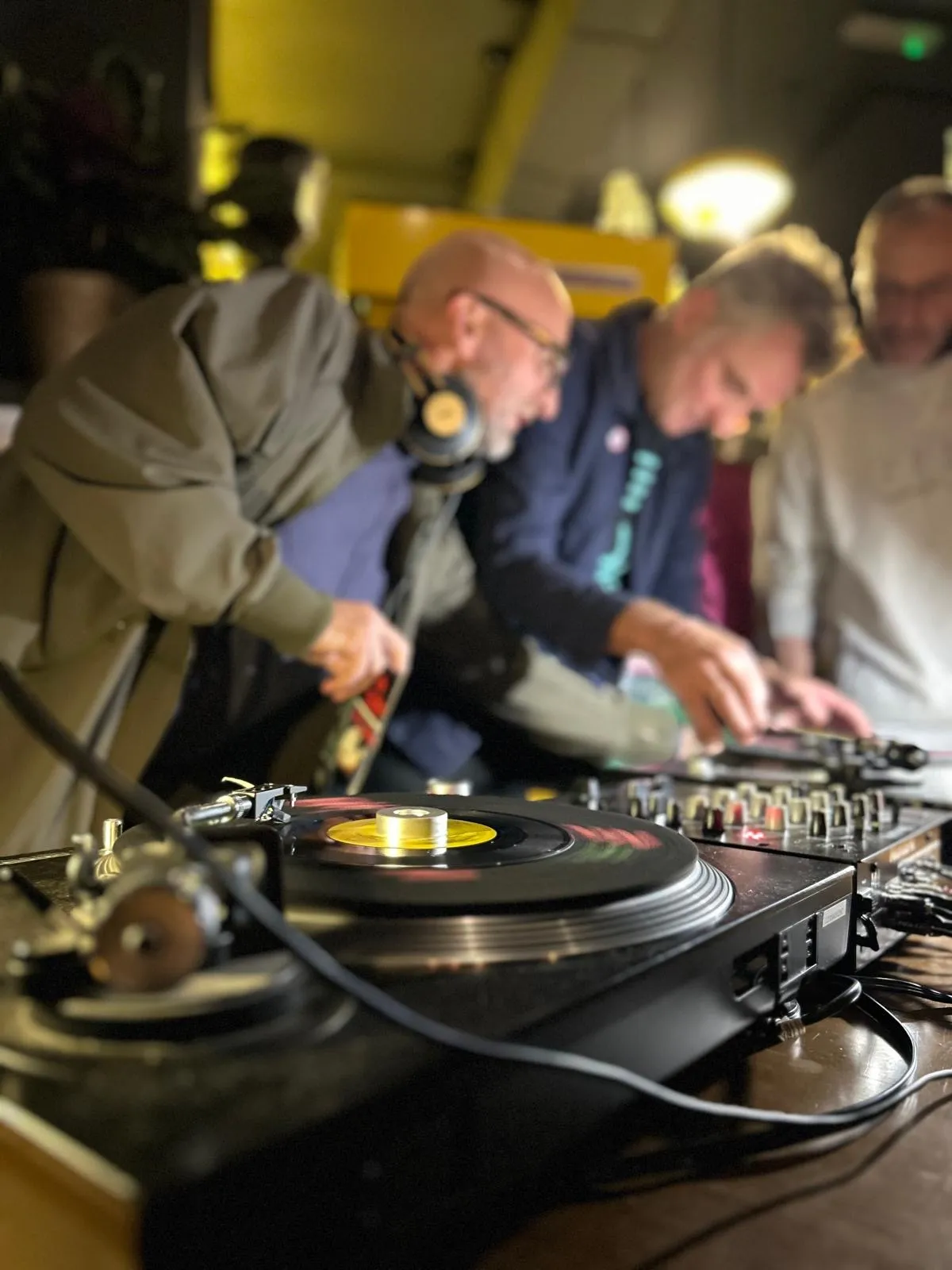 People gathered at the decks during a vinyl night at Art Club